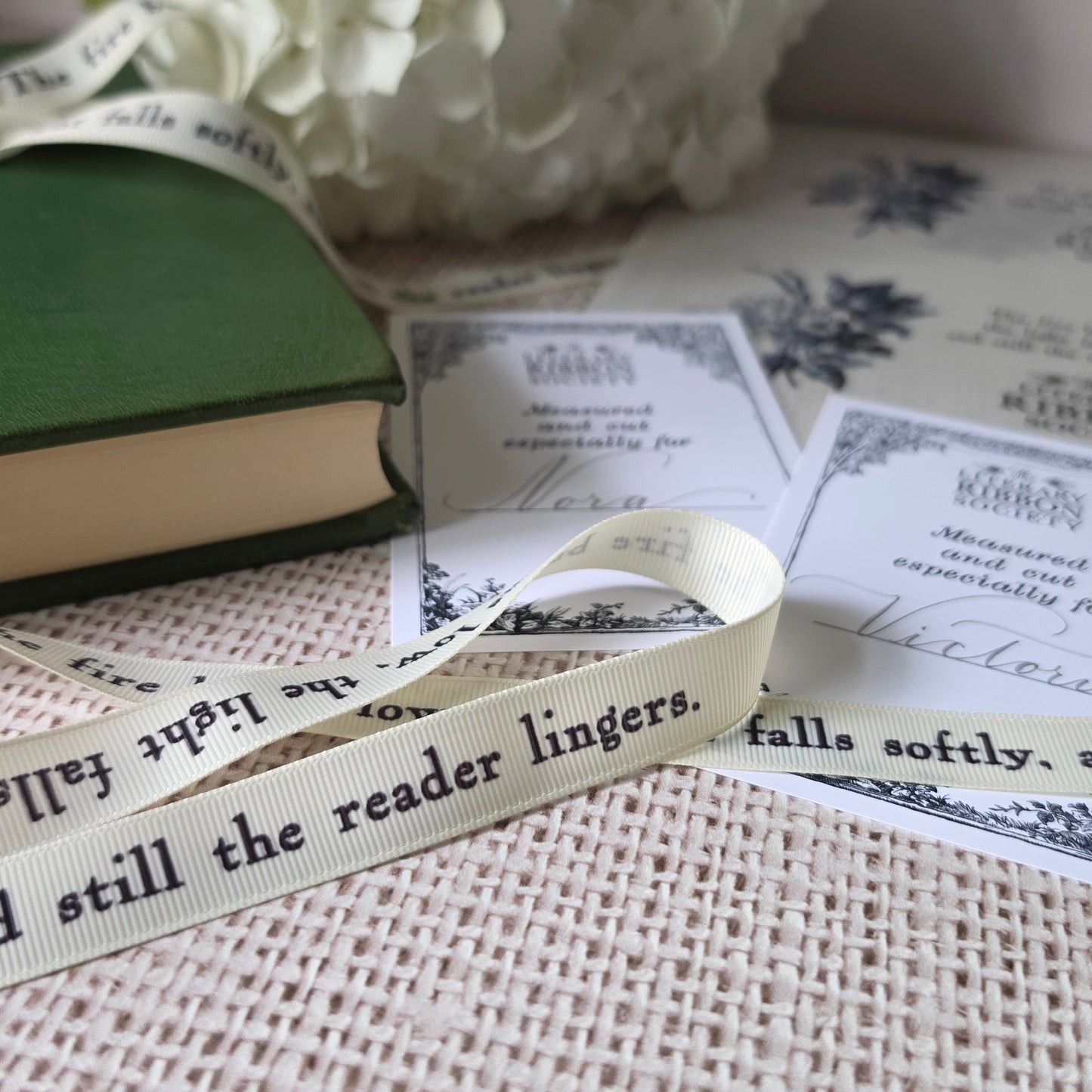 Close-up of cream grosgrain ribbon printed with literary quote