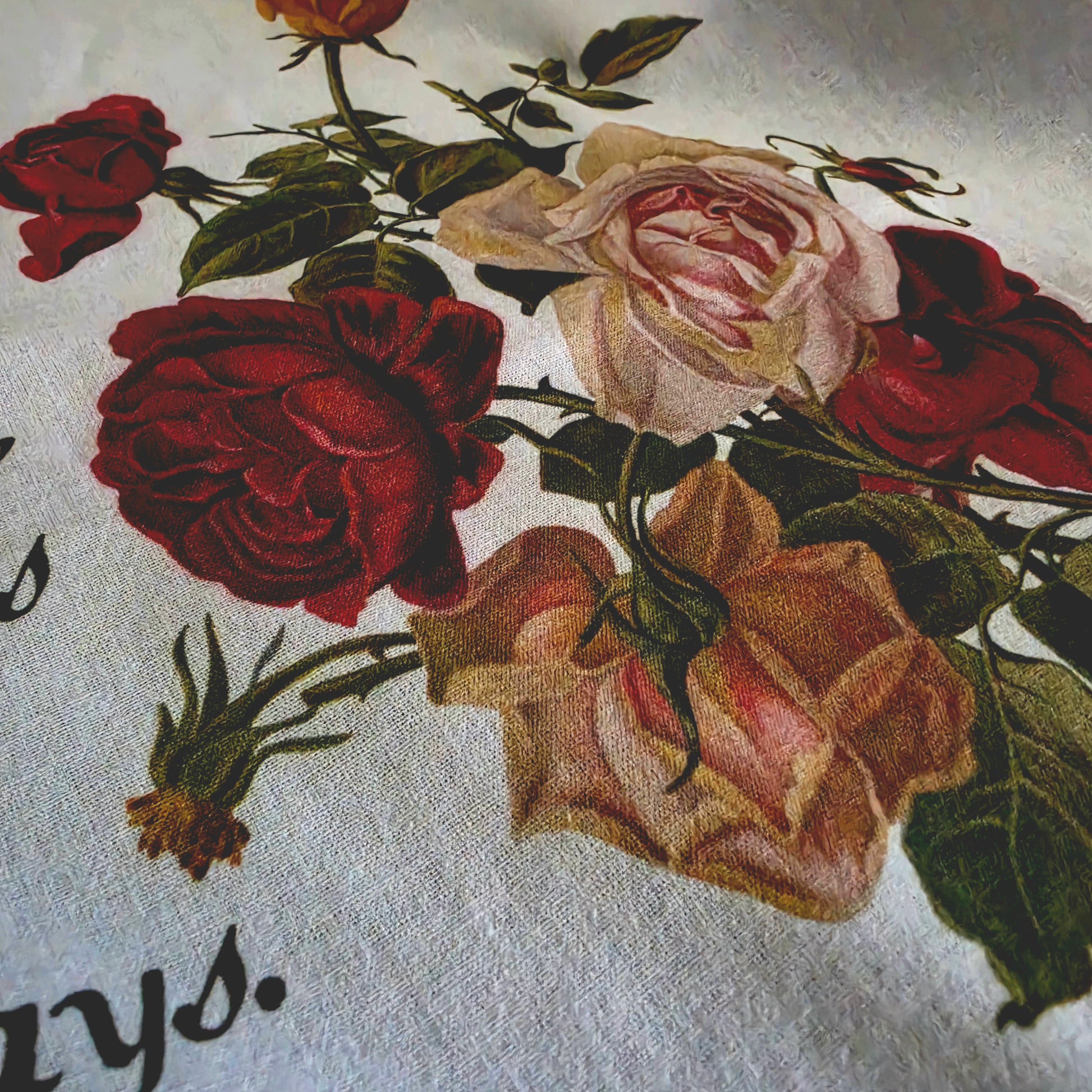 Close-up of vintage rose floral print on white kitchen towel with Claude Monet quote