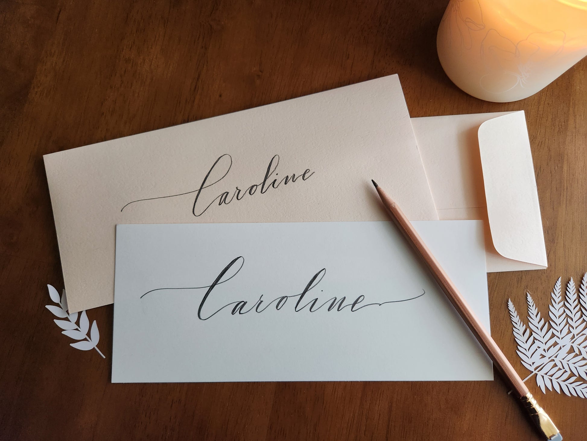 Six-Penny Stamp - Calligraphy of the name 'Caroline' on a piece of paper with an envelope.