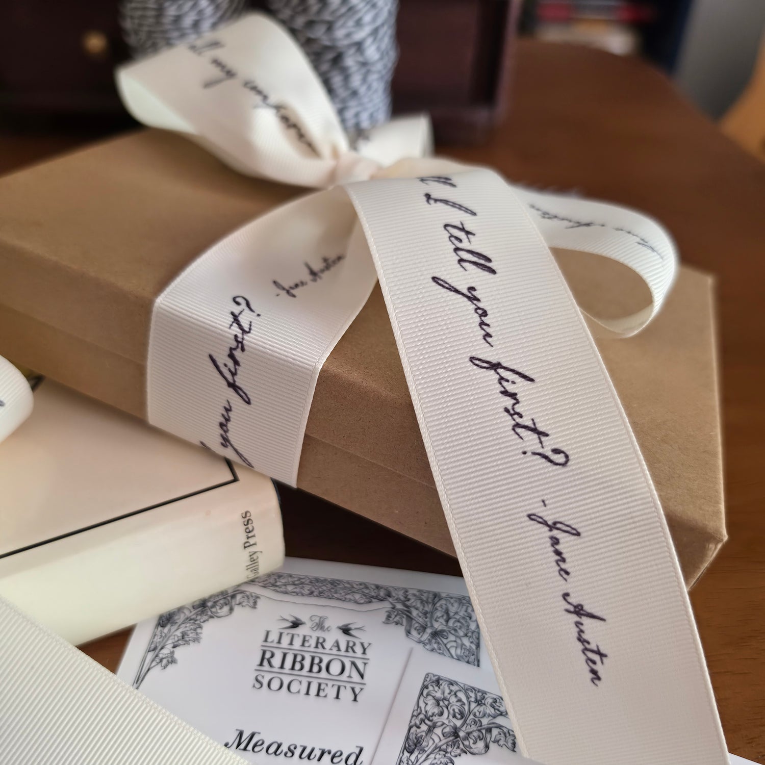 Books with decorative literary quote ribbons and cards on a wooden surface