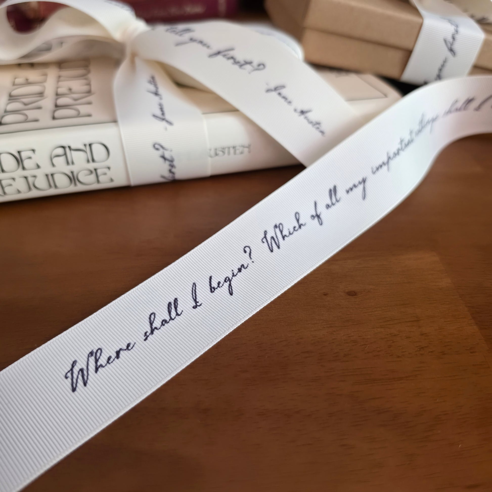 Books with decorative literary quote ribbons and cards on a wooden surface