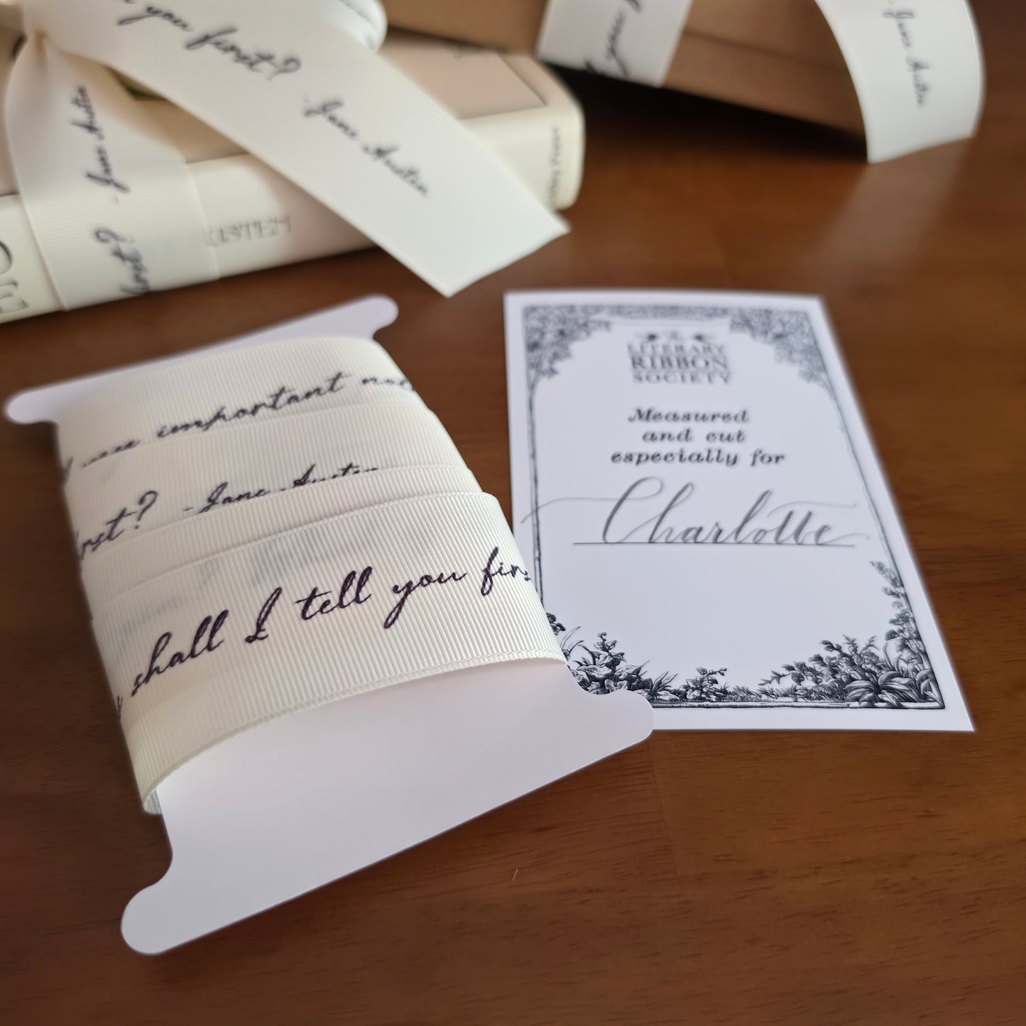 Books with decorative literary quote ribbons and cards on a wooden surface