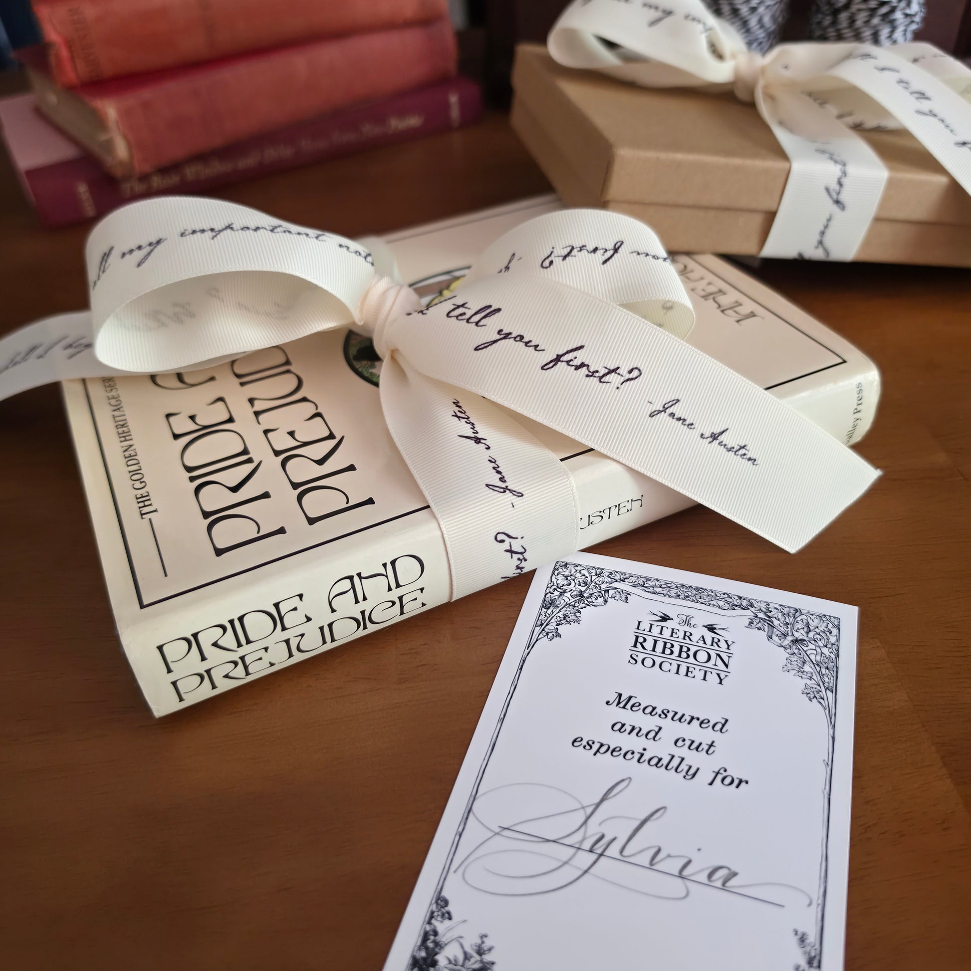 Books with decorative literary quote ribbons and cards on a wooden surface