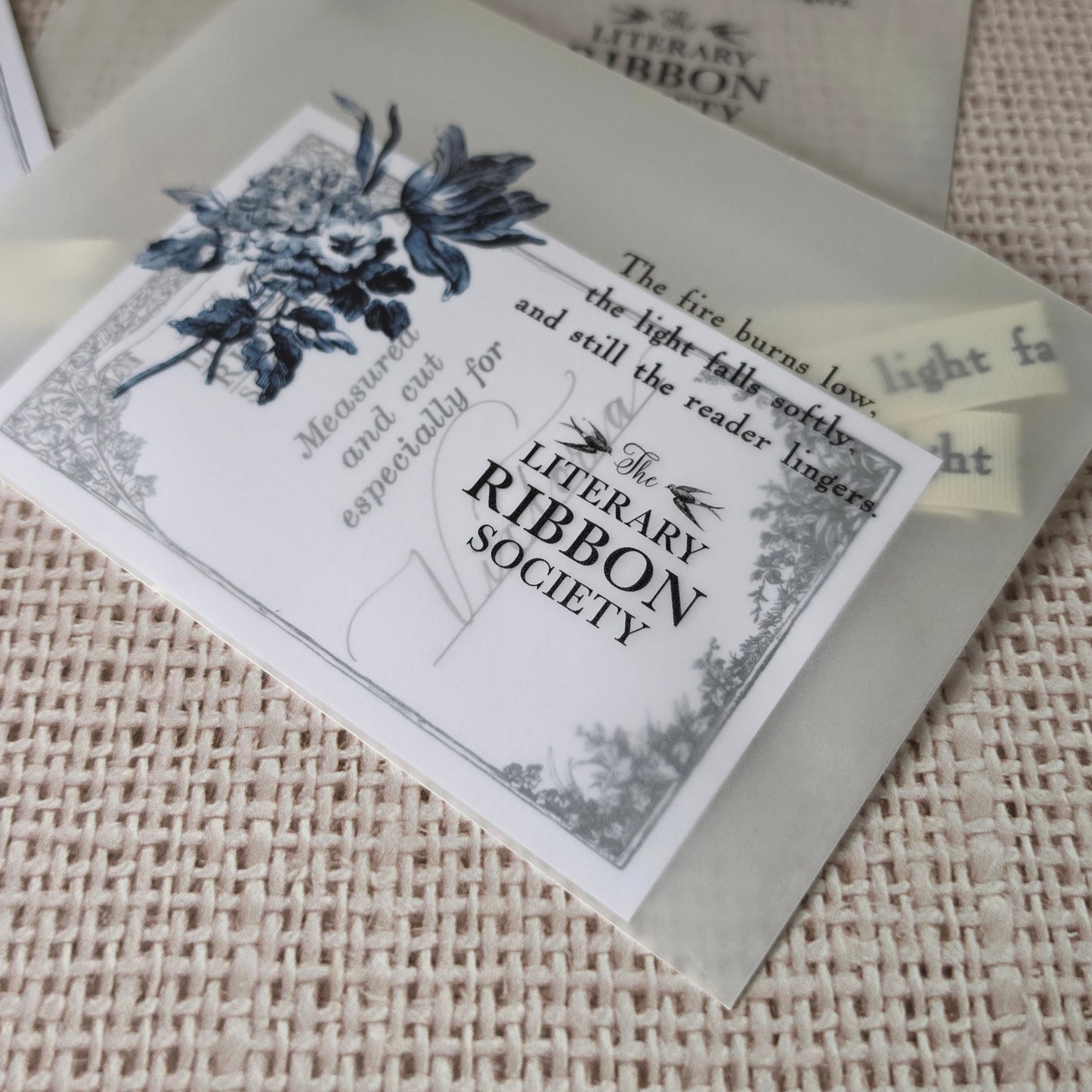 Literary Ribbon Society packaging with vellum sleeve and personalized ribbon card