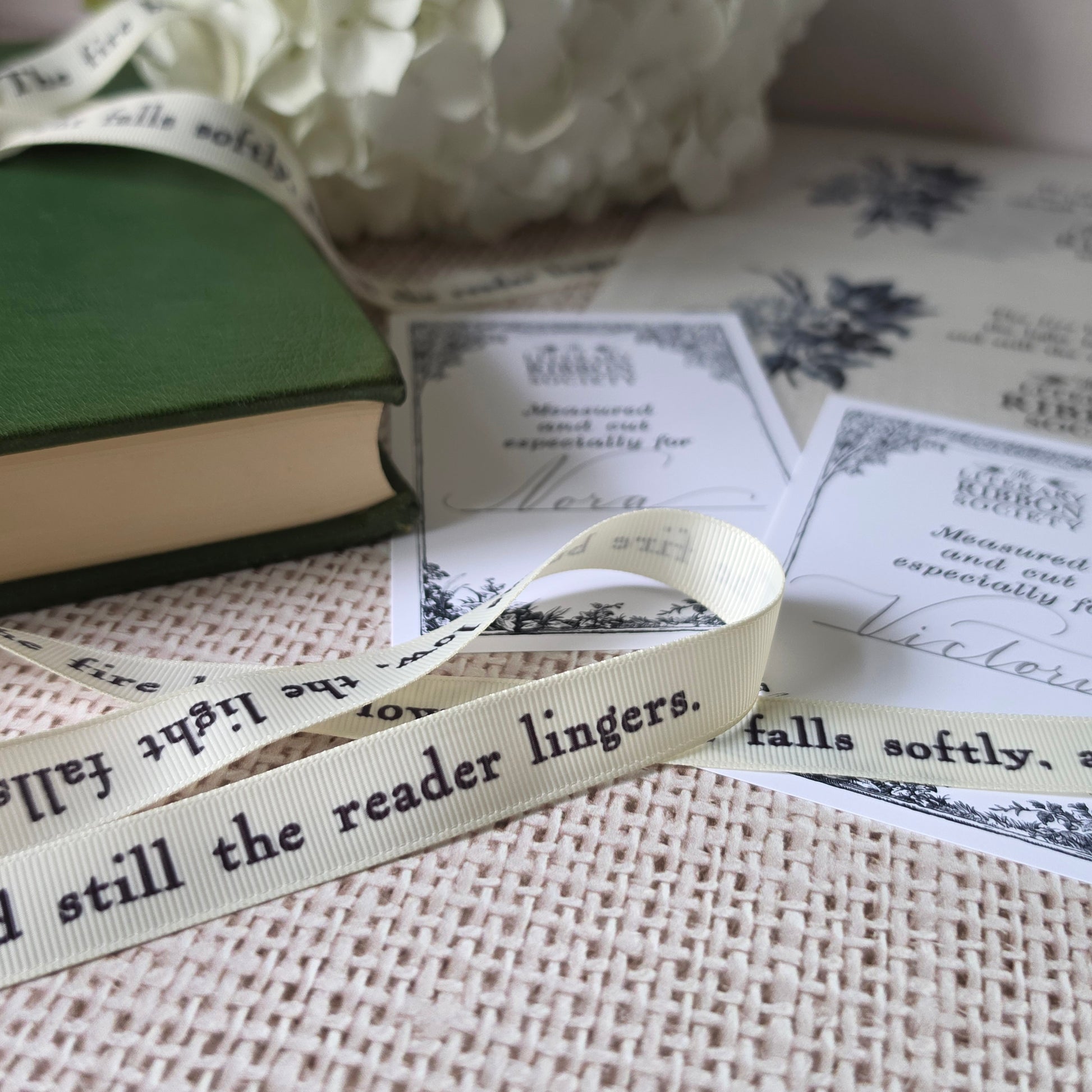 Close-up of cream grosgrain ribbon printed with literary quote