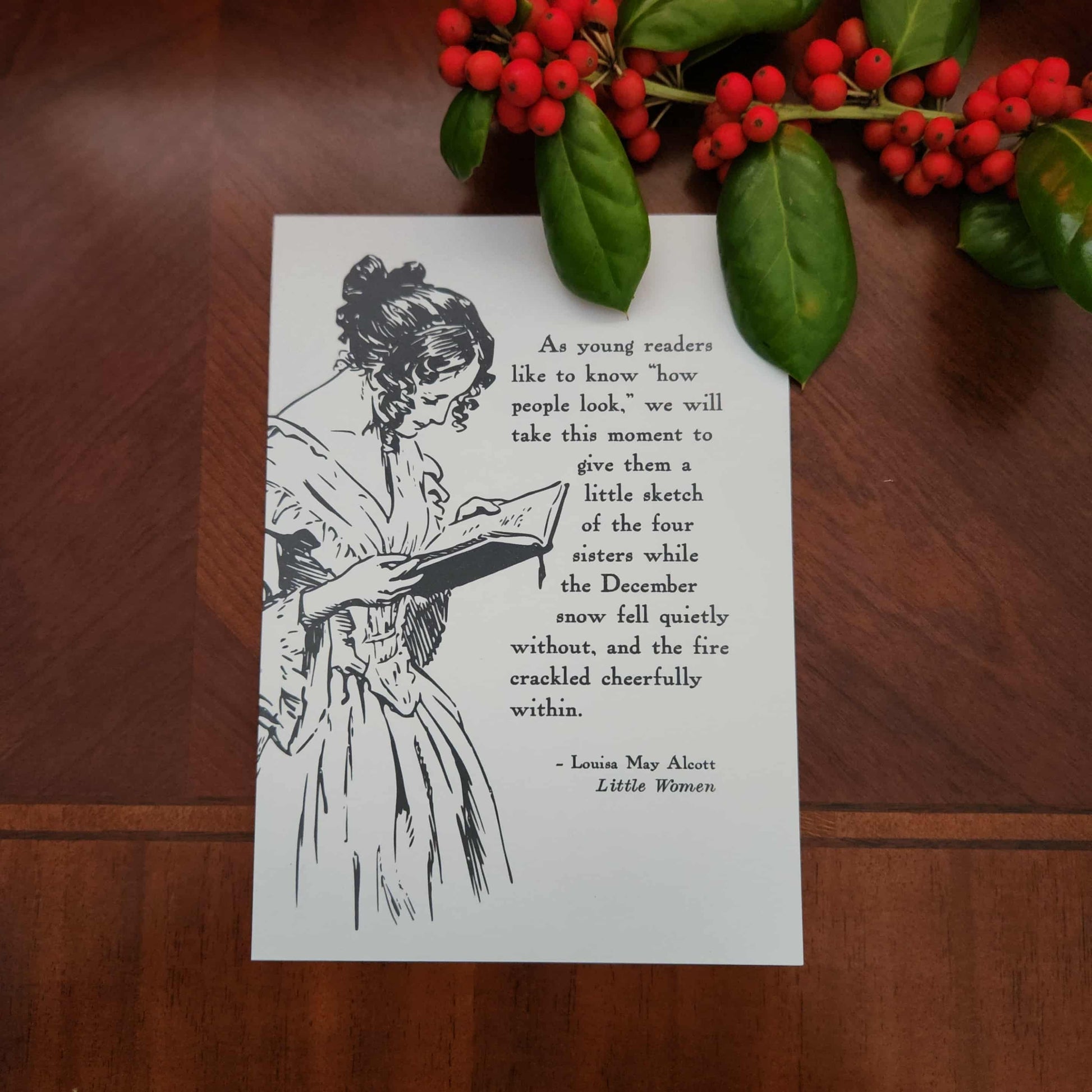 Art print from The Prose & Post Society with illustration of a woman reading, with quote from Little Women on a wooden surface with holly berries.