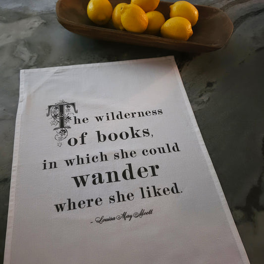 The Wilderness of Books cotton tea towel featuring a Louisa May Alcott quote