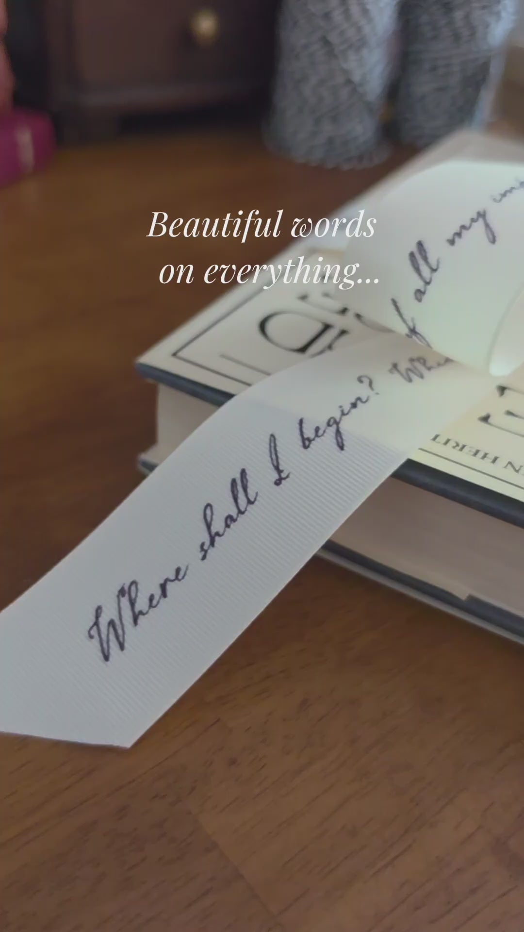 Books with decorative literary quote ribbons and cards on a wooden surface